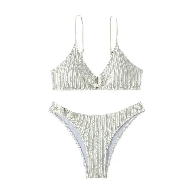 White women's V-neck swimsuit with split beach design, showing top and shorts.