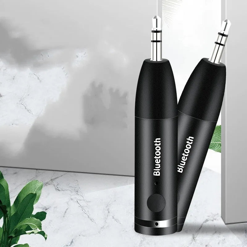 Black Bluetooth audio receiver for car stereo with AUX connection measuring 70mm by 14mm