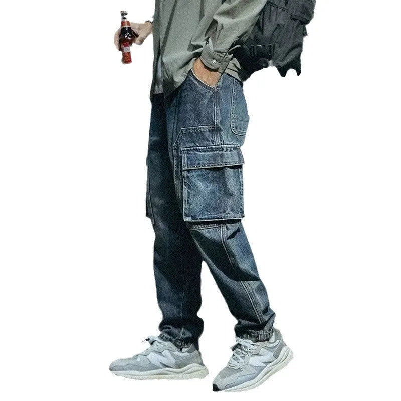 Blue men's loose straight-leg retro-style stretch denim trousers on a plain background.