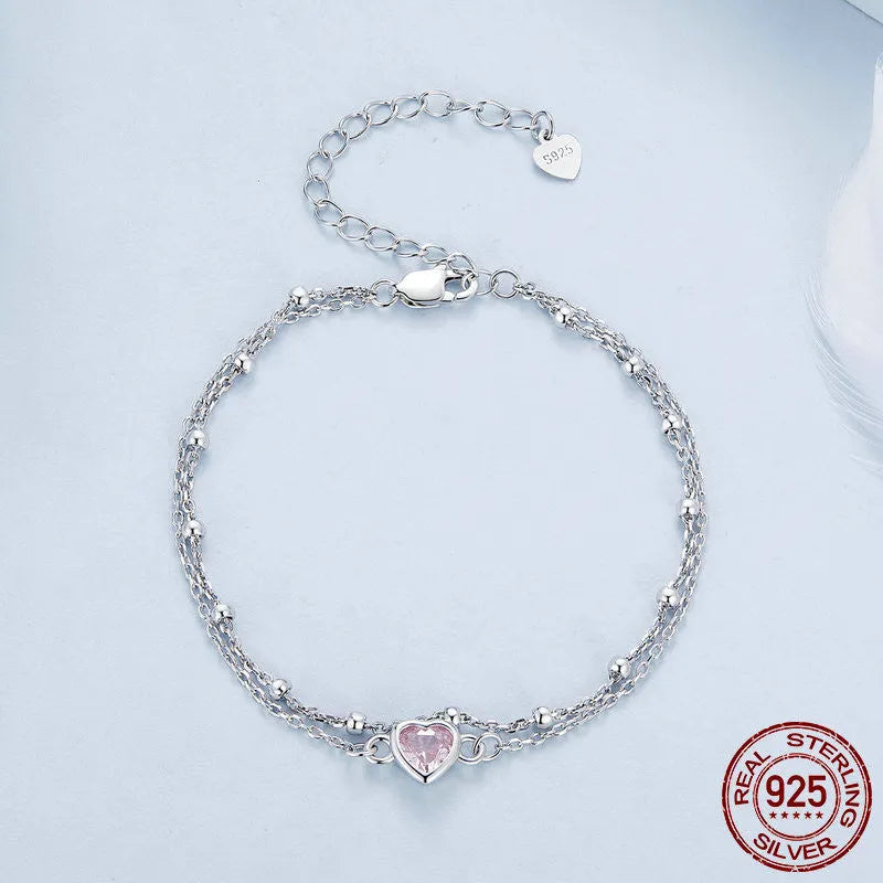 Women's 925 sterling silver bracelet with small heart-shaped pendant on an adjustable chain.