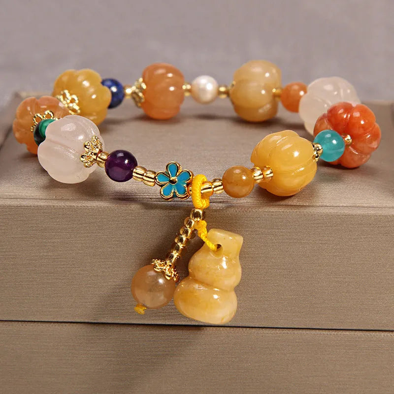 Yellow agate crystal bead bracelet with khaki silk cord and gold tone sliding closure.