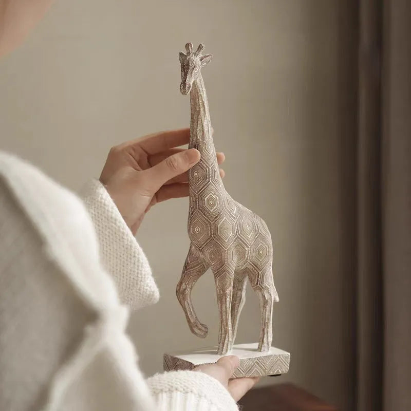 Wood colour synthetic resin giraffe ornament measuring 30.5cm tall on a shelf.