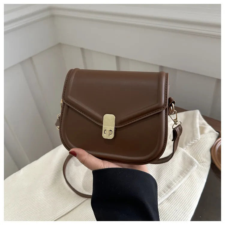 Soft PU leather clamshell shoulder messenger bag in a horizontal square shape.