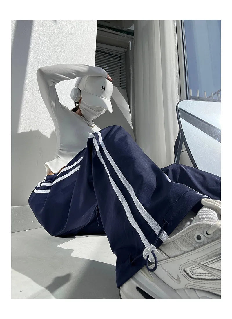 Low-waist loose straight-leg trousers with ribbon parallel bars detail in navy blue