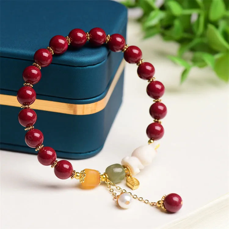 Natural cinnabar bracelet with rabbit charm for women, shown in 8mm and 10mm bead size options.