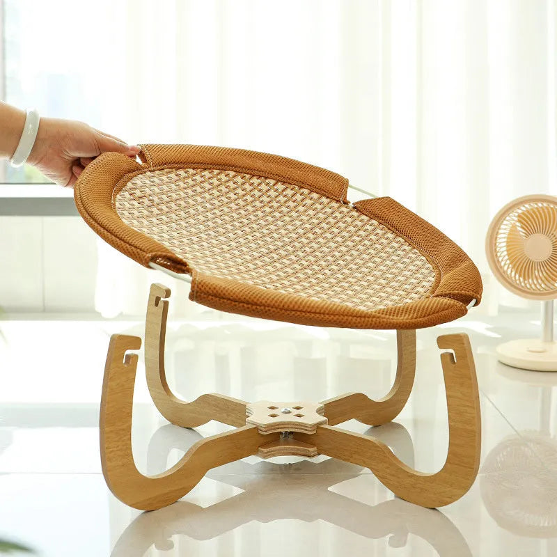Brown woven rattan hammock pet bed measuring 46cm square with elevated design