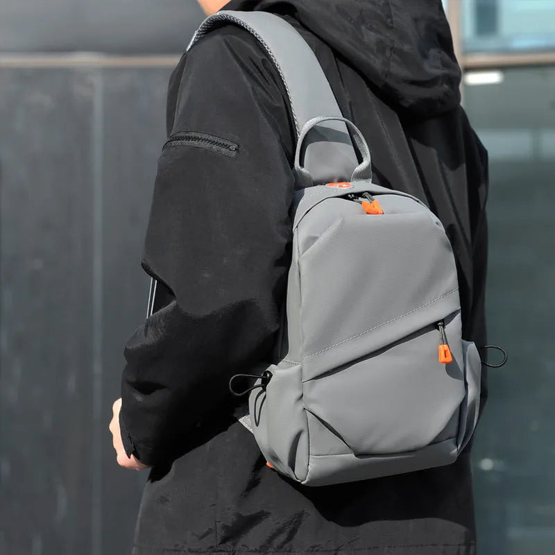 Men's black casual crossbody bag with a single shoulder strap made from waterproof polyester.