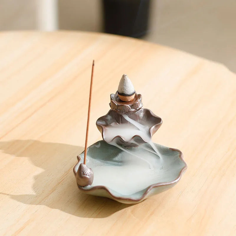 Ceramic reverse flow incense burner with purple clay construction and traditional good luck decorative motifs