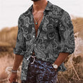 Man wearing a loose-fit bohemian-style shirt with a vibrant 3D floral print and long sleeves.