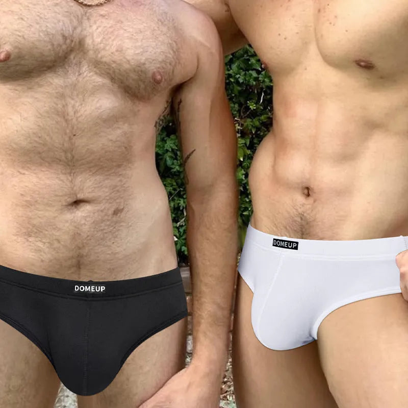 Men's low-waist seamless briefs in white, black, and pink solid colours showing hip-lifting design