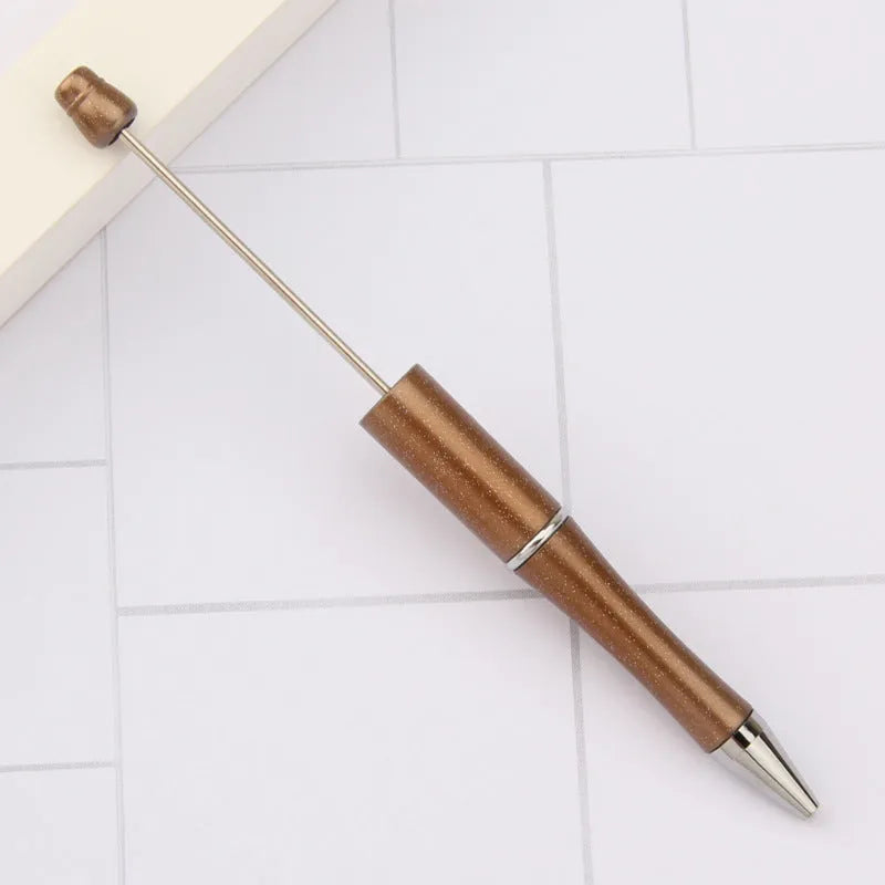 Ballpoint pen with colourful spinning plastic beads on barrel, shown in a gradient purple finish.