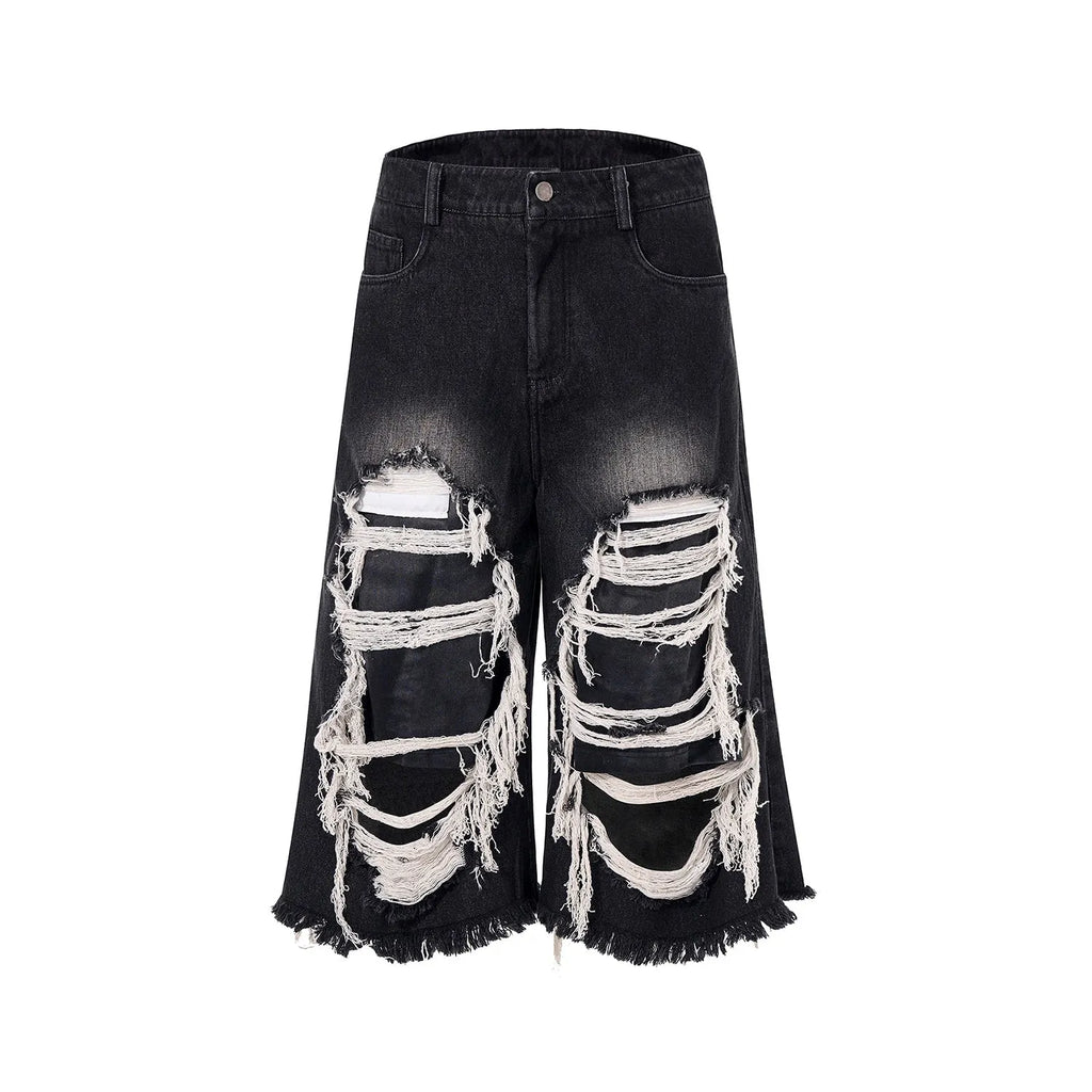 Women's black cropped wide leg jeans with distressed ripped patches and high waist