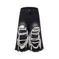 Women's black cropped wide leg jeans with distressed ripped patches and high waist
