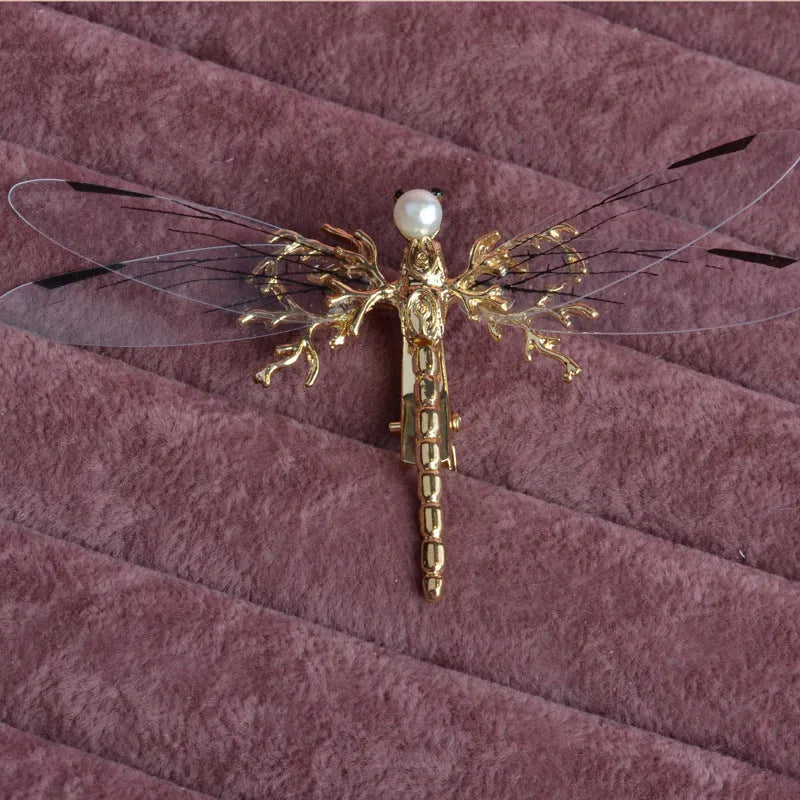 Golden electroplated alloy dragonfly side clip headdress for women.