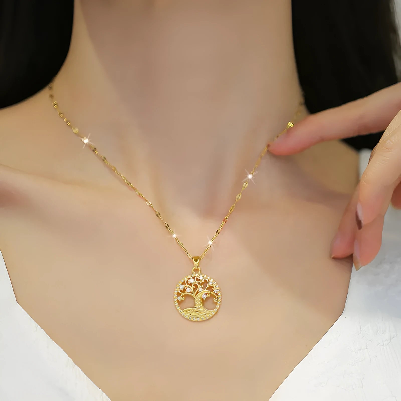 Gold plated stainless steel necklace with mother of pearl lucky tree pendant and cross elements on a lip chain
