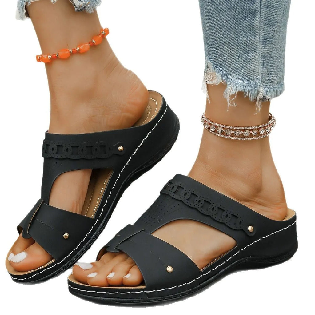 Blue Roman style slippers with a fish mouth toe holder and slope heel on a rubber sole.