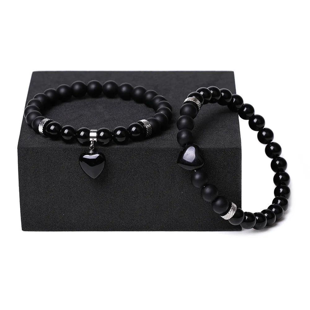 Natural stone couple bracelet set showing two matching bracelets with heart-shaped polished stone pendants