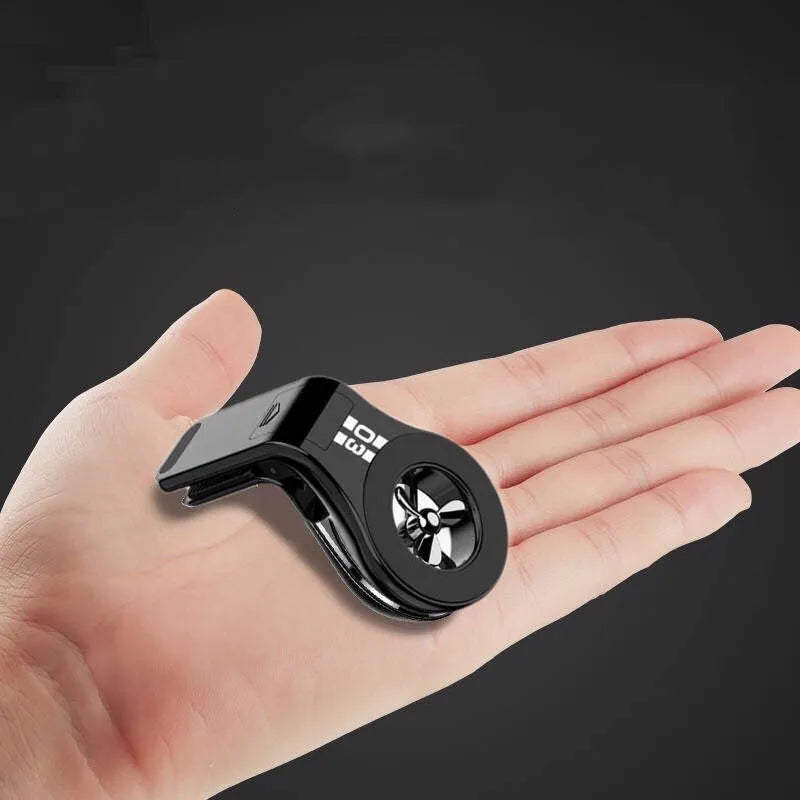 Magnetic car phone holder mounted on vehicle air vent with smartphone attached showing adjustable rotation mechanism