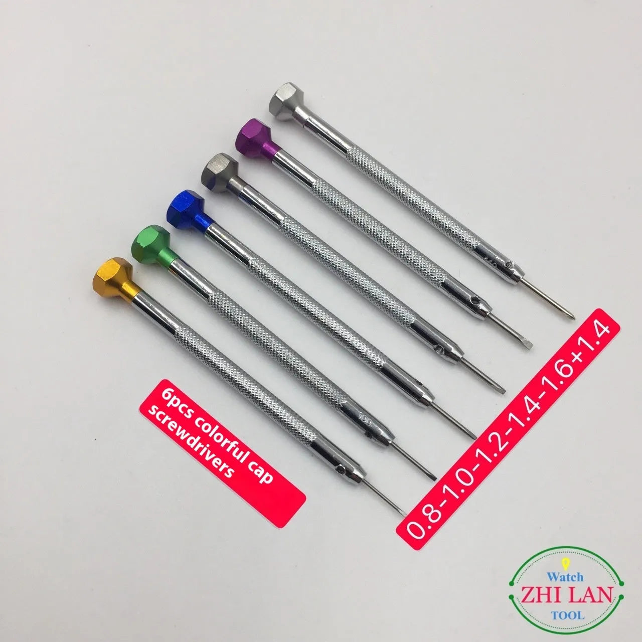Six colour-coded watch repair screwdrivers with aluminium handles laid out on a surface.
