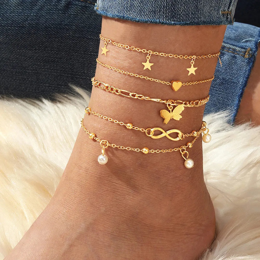 Butterfly pearl heart anklet set containing four alloy foot chain jewellery pieces for women