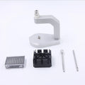 Silver-toned tool steel press strap removal tool for watches and jewellery on a plain background.