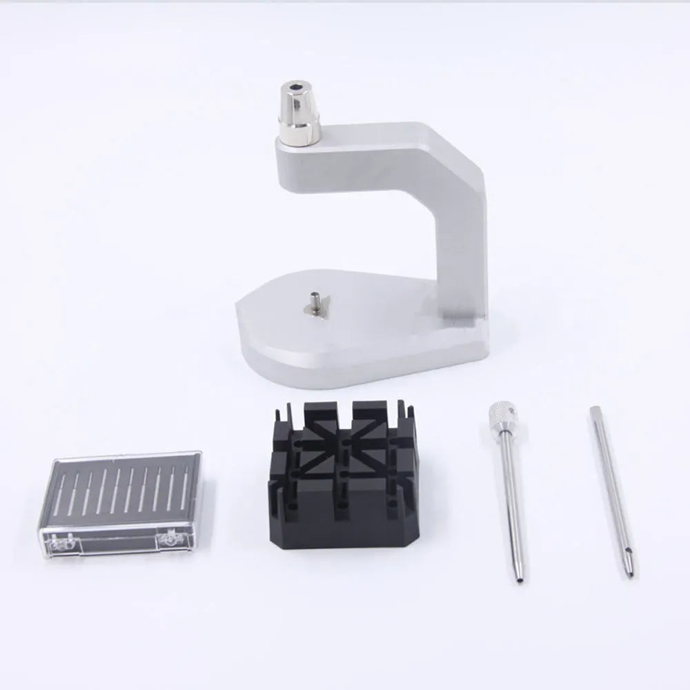 Silver-toned tool steel press strap removal tool for watches and jewellery on a plain background.