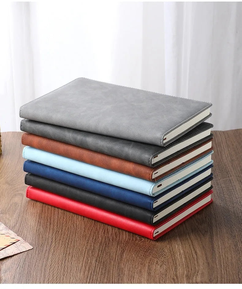 A5 notebook with a PU leather cover, open to show wood-free paper pages.