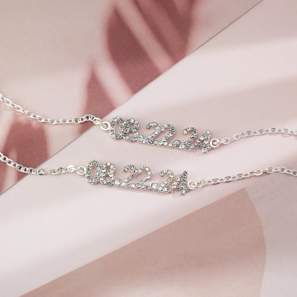 Stainless steel digital bracelet or necklace with diamond studs and clear number display.