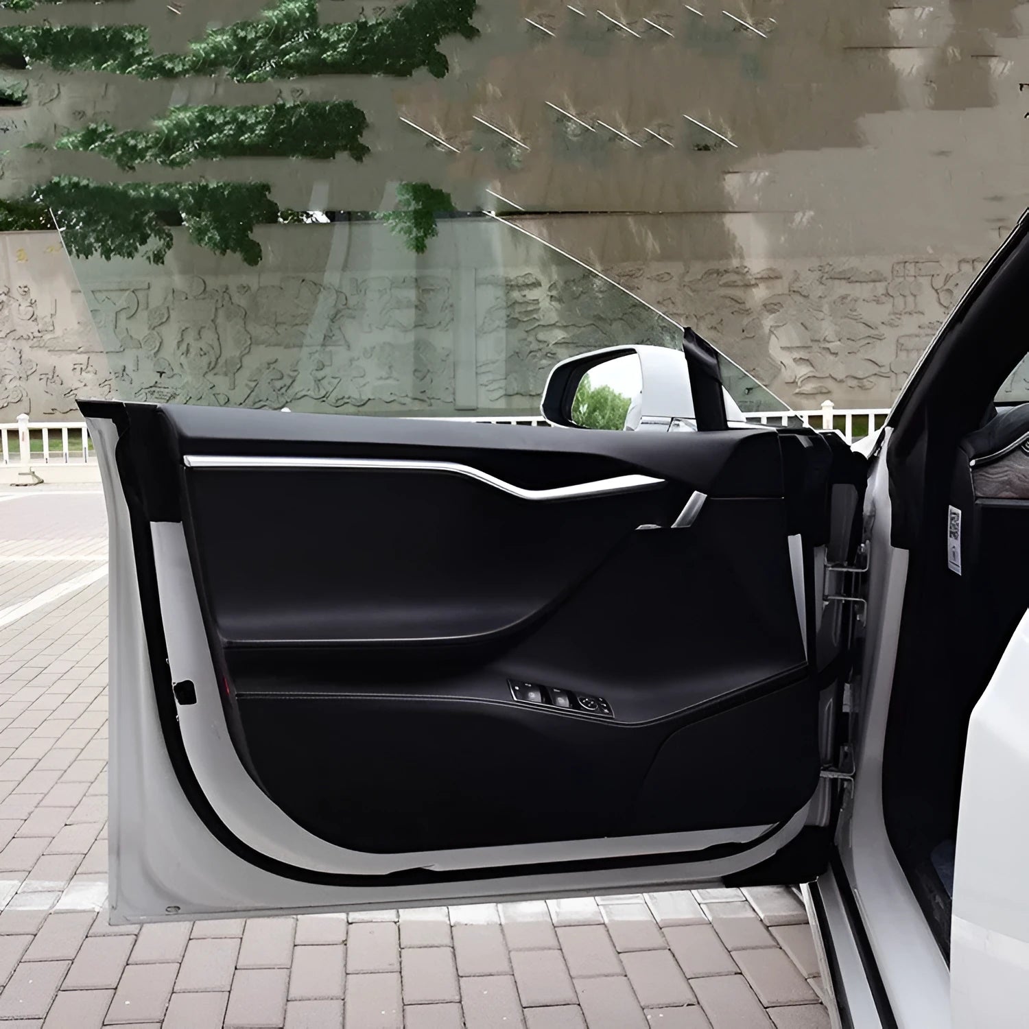 Carbon fibre pattern protective film for Tesla Model S car door interiors.