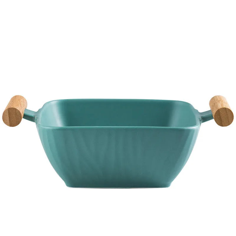Modern ceramic bowl with irregular organic shape and coordinating lid in porcelain