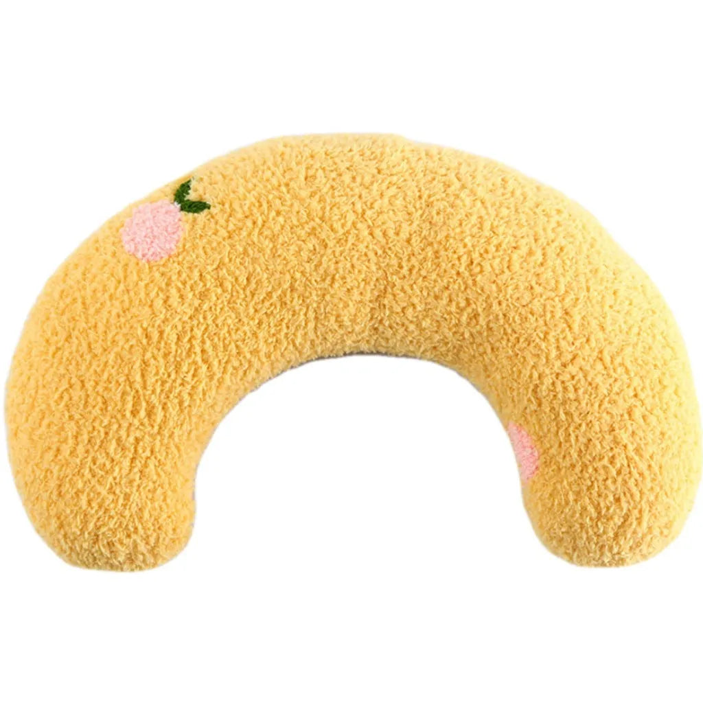 Small blue half-donut shaped pet pillow bed for cats or small dogs on a carpet.