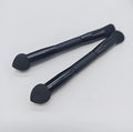Elegant black double-headed makeup brush with a miter sponge and concealer brush on a wooden handle