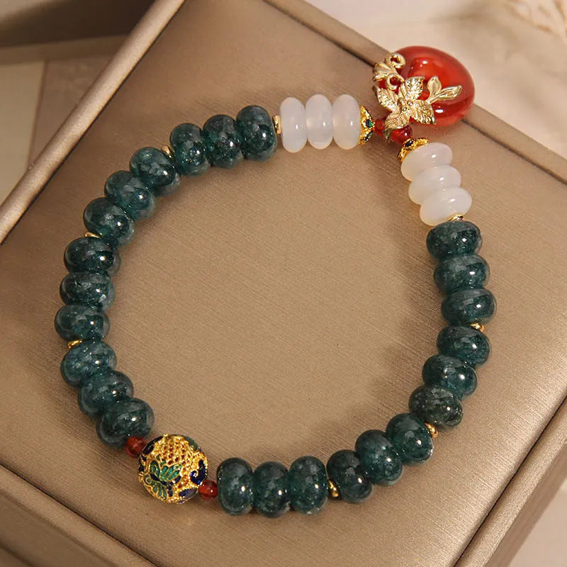 Blue water jade and red agate stone bracelet with peace buckle closure on crystal band