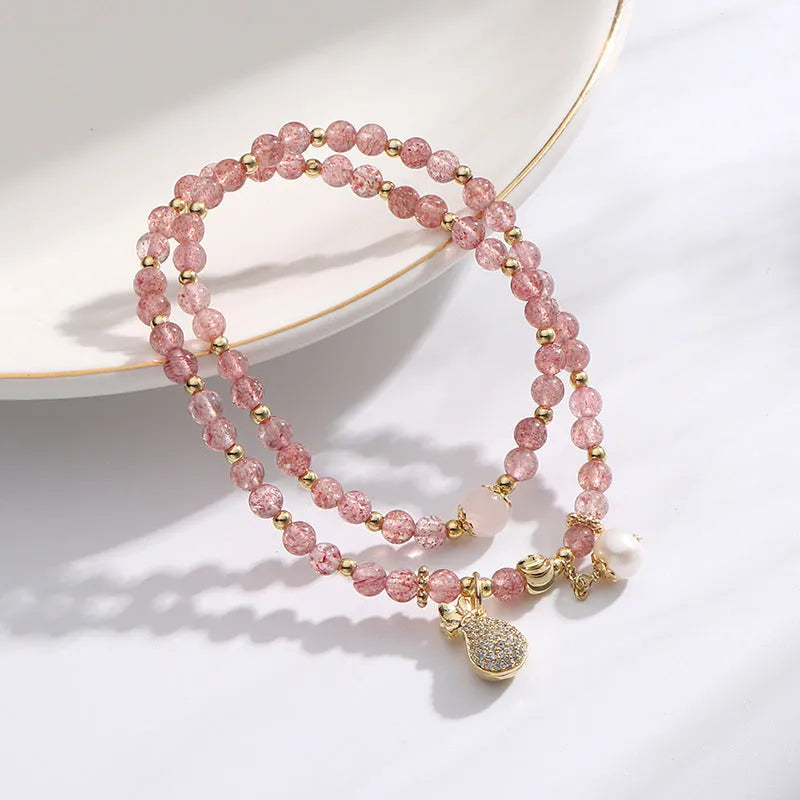 Women's strawberry quartz crystal bracelet with a geometry shape design.