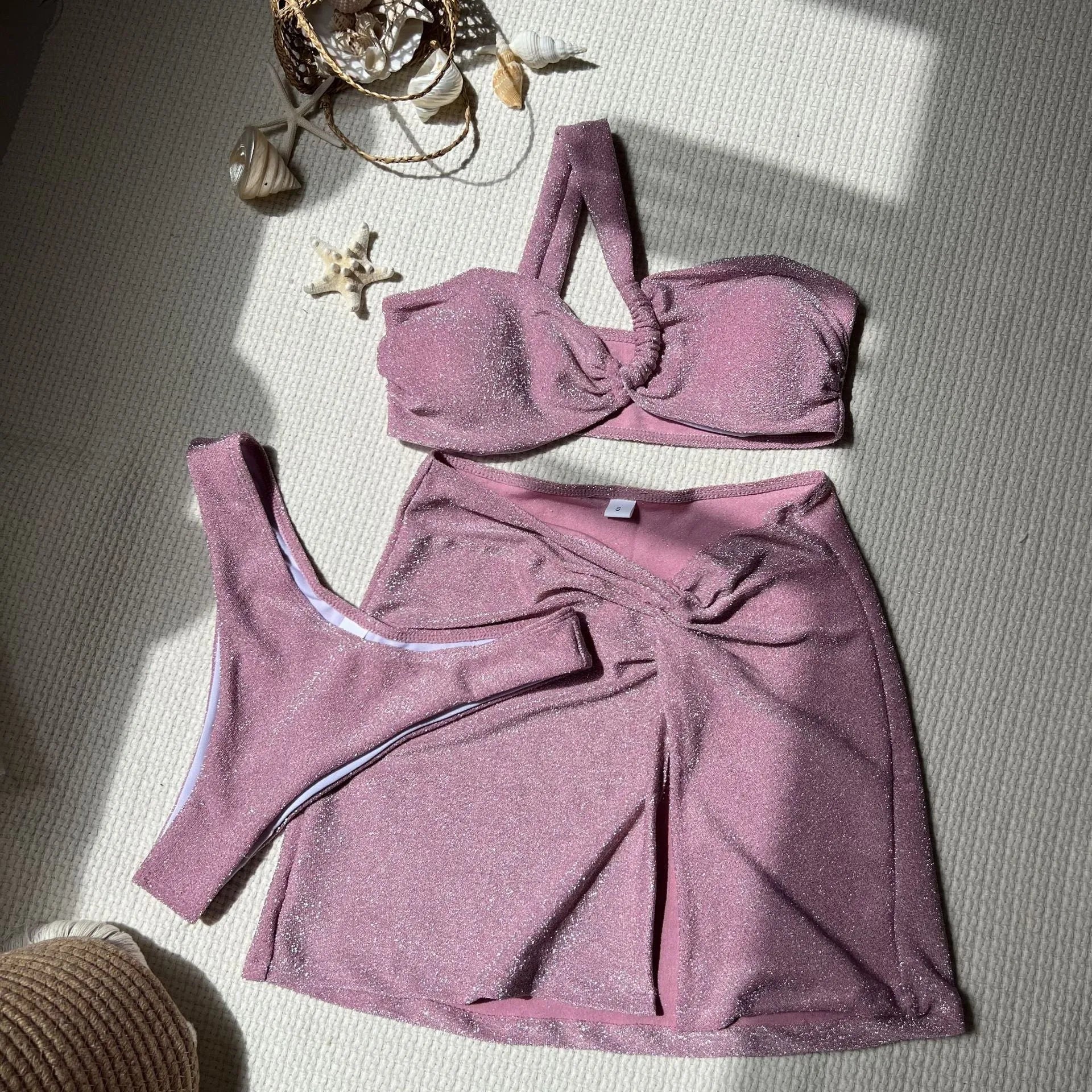 Women's one-shoulder tube top swimsuit three-piece set in glossy polyester fabric.
