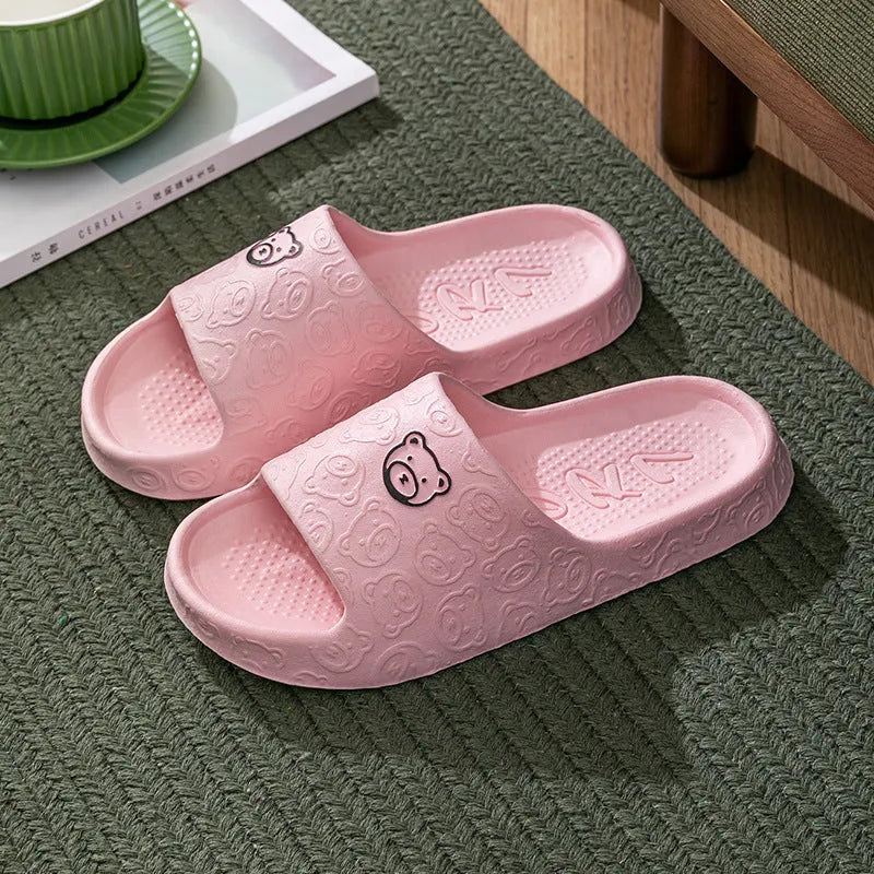 Pair of cute bear EVA indoor slippers in pink with thick non-slip soles.