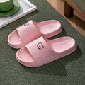 Pair of cute bear EVA indoor slippers in pink with thick non-slip soles.