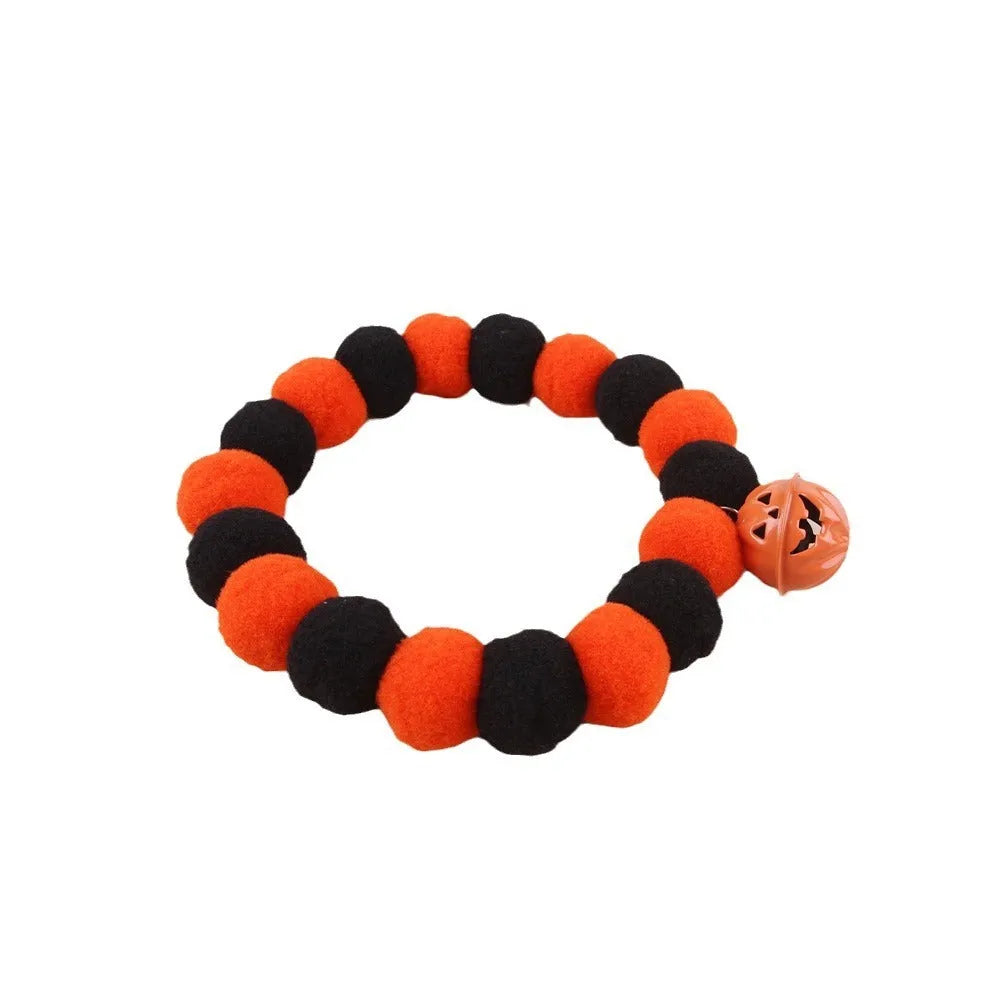 A pumpkin-themed adjustable cat collar for Halloween, shown in three sizes.