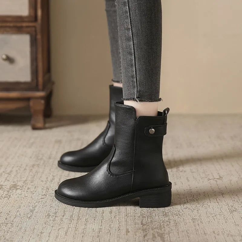 Black women's ankle boots with a side zip and round toe on a low heel.