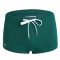 Men's lace nylon low waist swimming trunks in boxer brief style on a solid colour background.