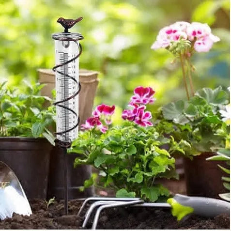 Cast iron bird rain gauge with glass measurement tube showing 0-800ml capacity