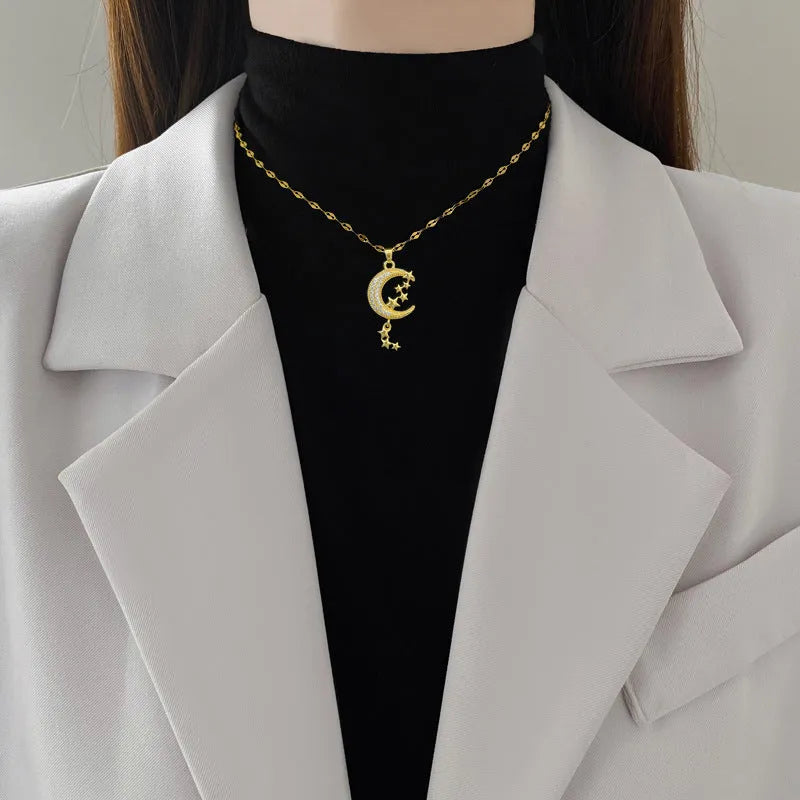 Stainless steel moon tassel necklace with geometric copper pendant and diamond detailing
