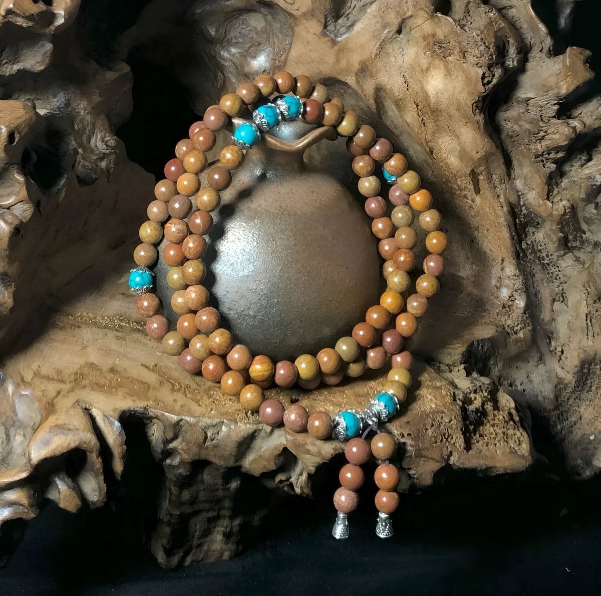 Handmade stone bead bracelet with 108 round geometric beads on a wrist.