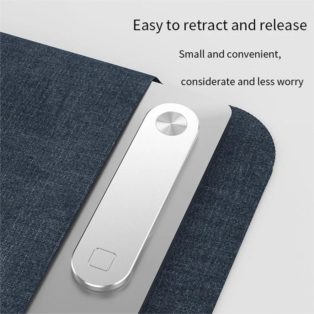 Black aluminium magnetic phone holder clipped to the side of a silver laptop.