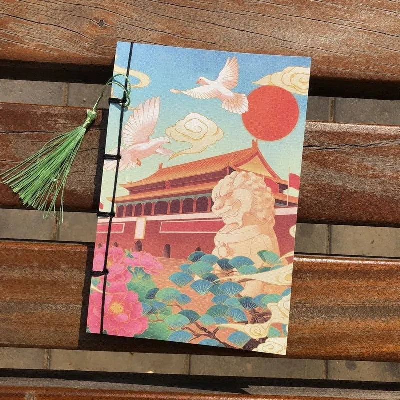 A5 antique wire-bound notebook with glossy embossed cover featuring a retro painting design, shown open.