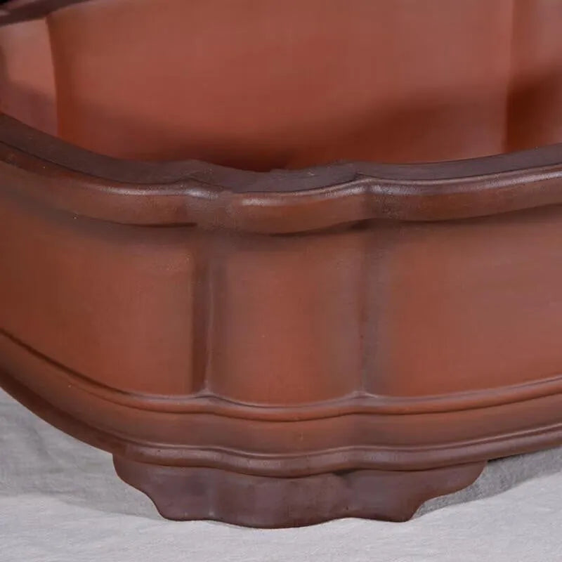 Large antique-finish Chinese purple clay flower pot with decorative tree stump and floral motifs.