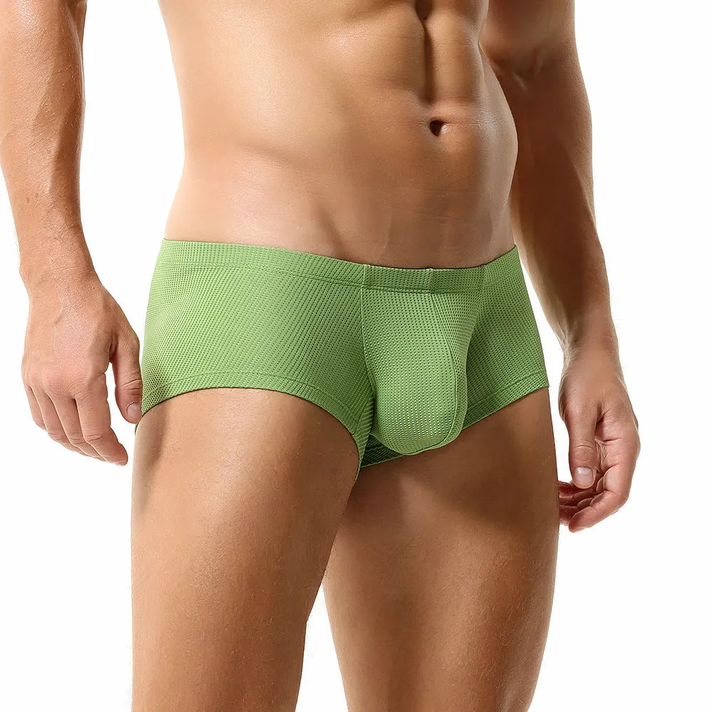 Men's low waist nylon boxer shorts in solid colours orange, blue, green, and white on a size chart.