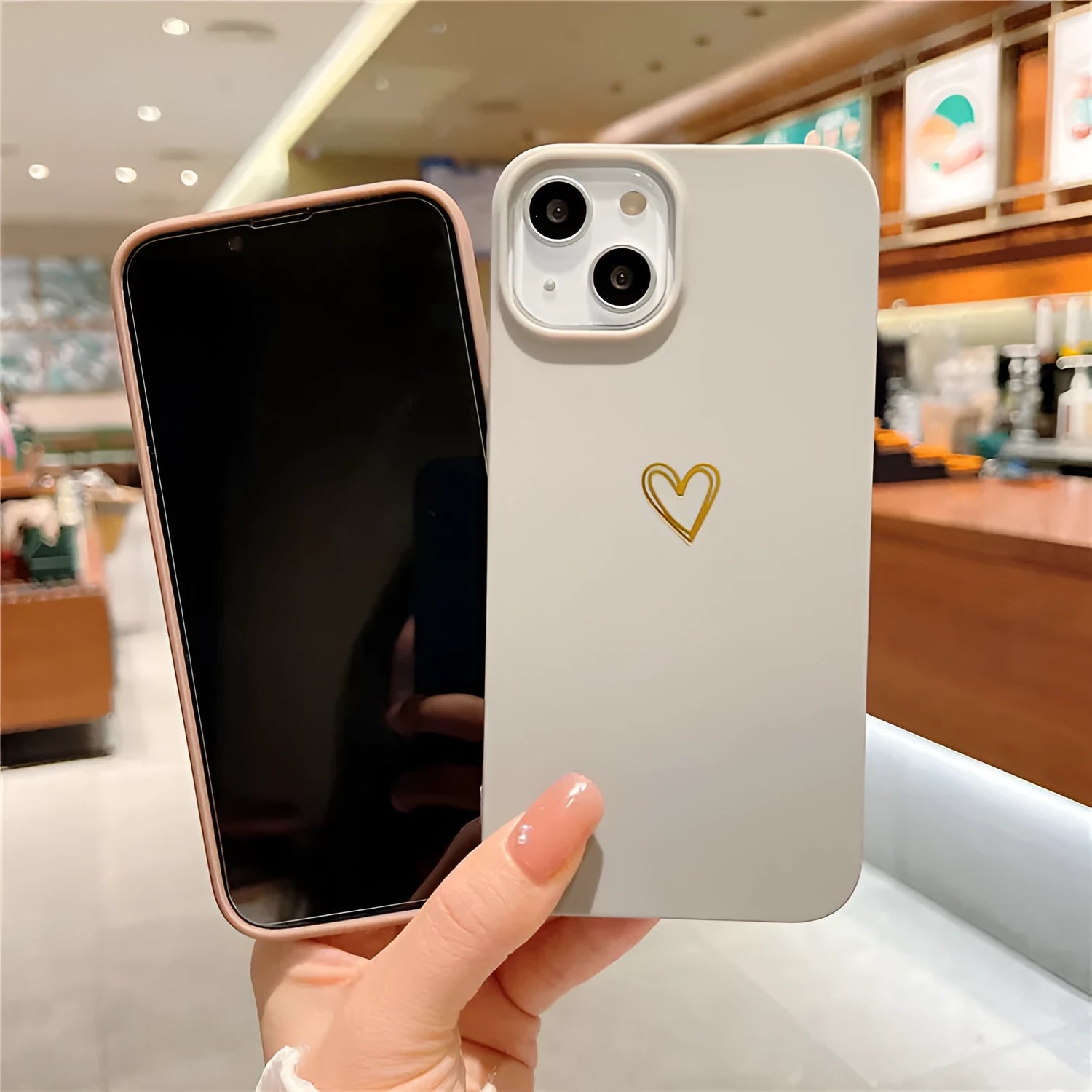 Brown silicone iPhone case with a hot stamped white love heart design on the back.