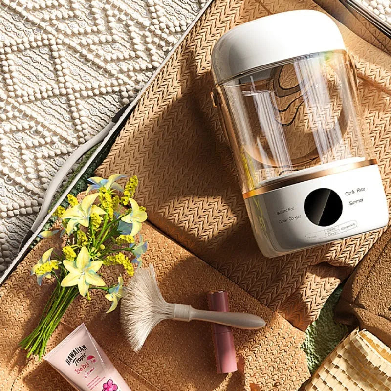 Compact white electric stew cooker with glass pot and digital display, shown with spoon.