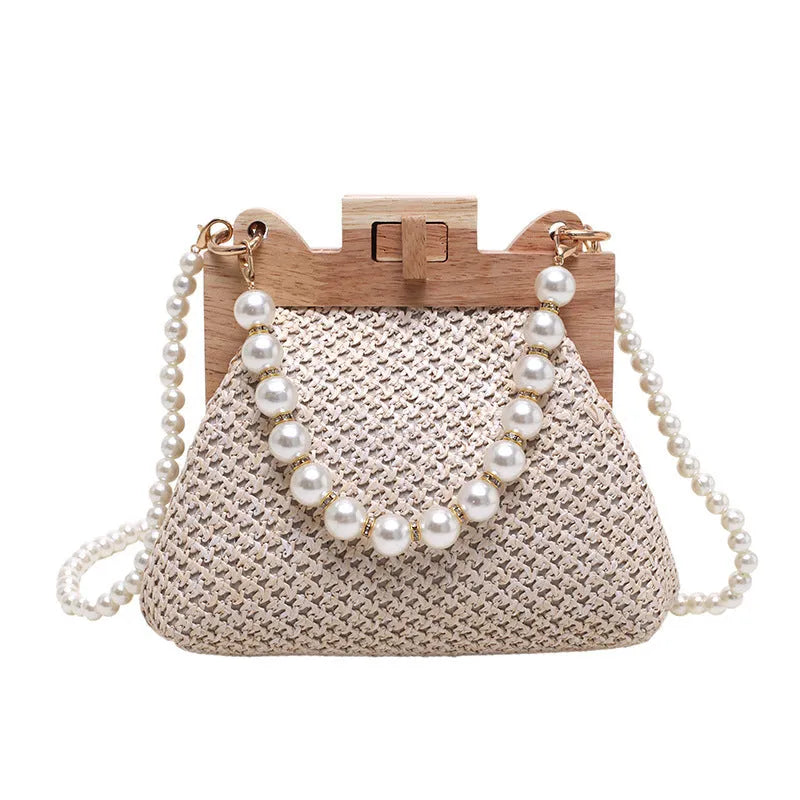 Women's woven straw beach bag with pearl chain shoulder strap in horizontal square shape